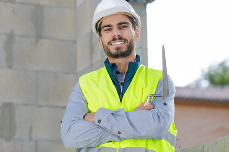 young engineer standing confidently with a crossed arms