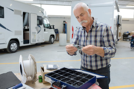 mechanic with tools in repair shopの写真素材