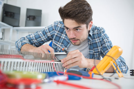 young man on a gas water heater repair