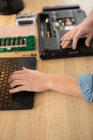 male engineer hands repairing laptop computer