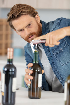 man opening bottles of wineの写真素材