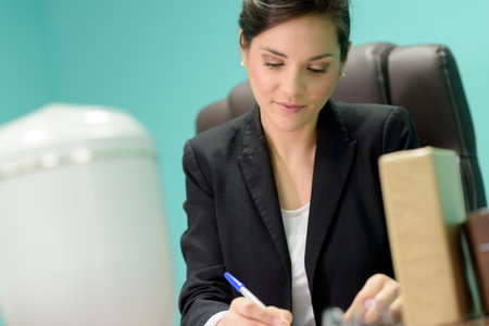 businesswoman sitting at tableの写真素材