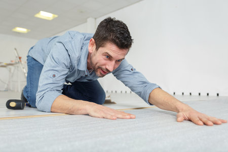 a worker cutting linoleum tape-measureの写真素材
