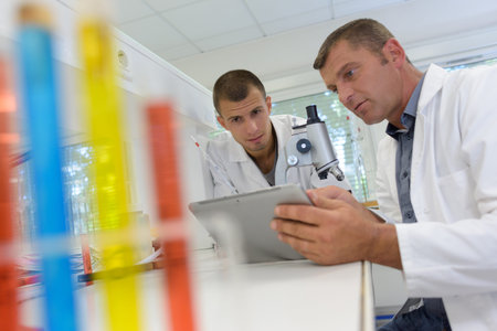 two scientists examining liquid in a test tube