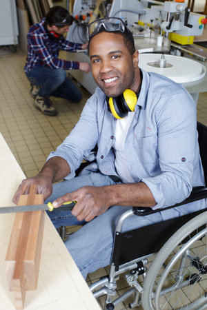 young man smiling in wheelchairの写真素材