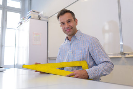 professor holding a set square