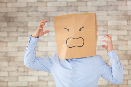 man wearing a cardboard faceの写真素材