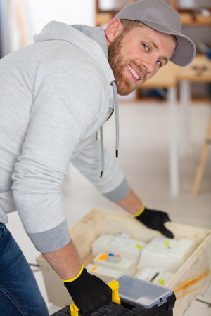young electrician craftsman taking tools