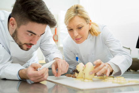 couple of confectioners making a dessertの写真素材