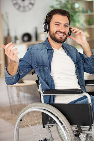 happy handsome young disabled student with headphones
