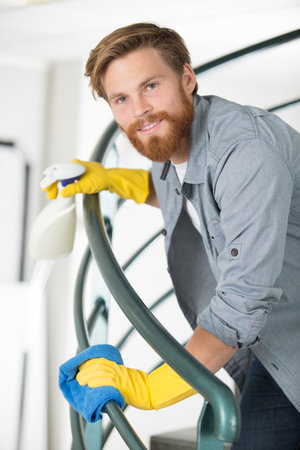 male worker wipes railing with a clothの写真素材