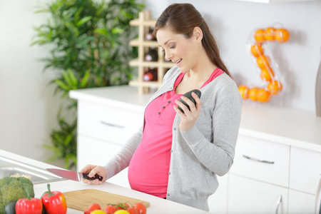 woman ready to cut an avocadoの写真素材