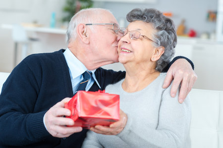 husband surprising wife with a giftの写真素材