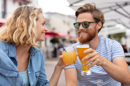 happy young couple beer cheersの写真素材