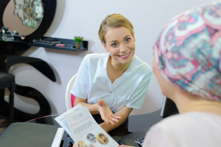 female client in beauty salon with a beauticianの写真素材