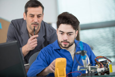 apprentice and teacher during engineering test