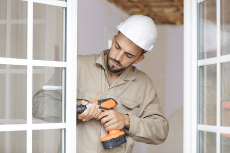 a male builder working on window