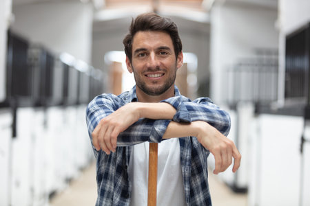 happy man working with horsesの写真素材