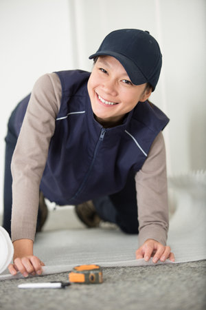 woman installing insulating layer on the floorの写真素材