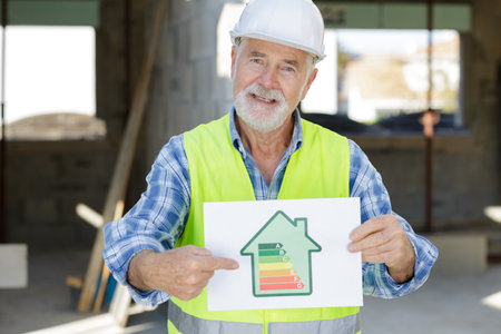 senior craftsman holding an electricity chartの写真素材