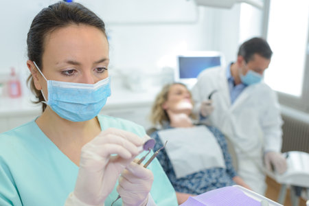 portrait of dentist preparing the toolsの写真素材