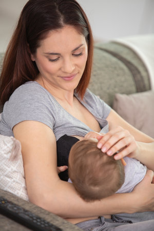 a mother is breastfeeding a babyの写真素材