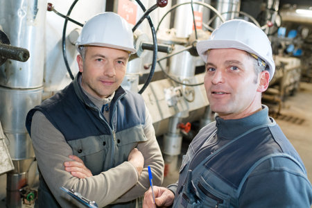 portrait of two workers in industrial plant