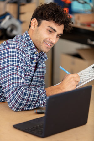 young man looking at paperの写真素材