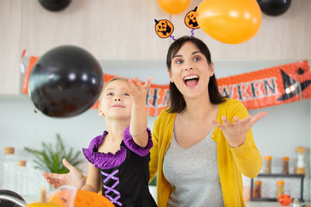 family mother and child daughter in costumes and makeupの写真素材