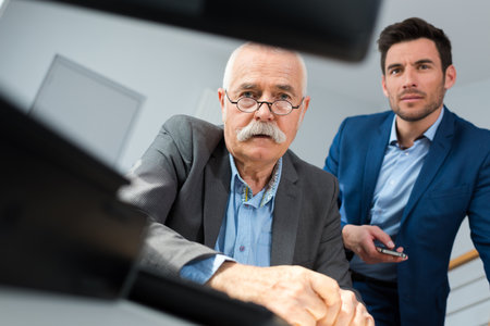 senior and junior businessmen in consultationの写真素材