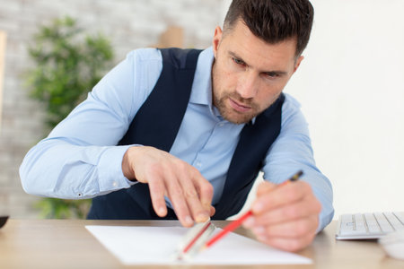 male architect draws a plan