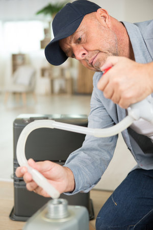 man filling the humidifier with waterの写真素材