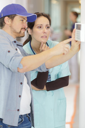 woman nurse talking to male technicianの写真素材