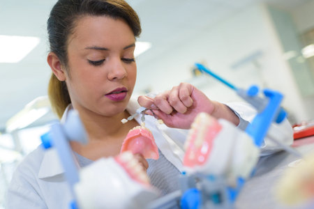 technician polishing or grinding a dental implant
