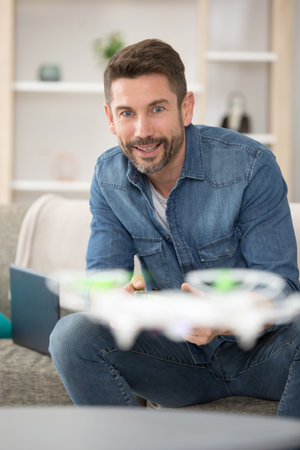 guy flying drone indoor