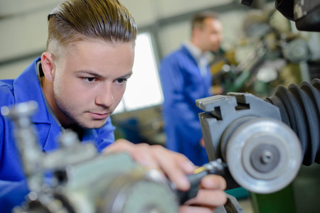 young engineer is using lathe