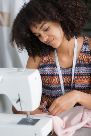 female fashion designer cutting fabricの写真素材