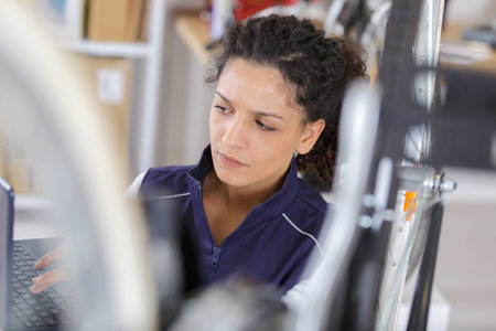 female bicycle mechanic in a workshopの写真素材