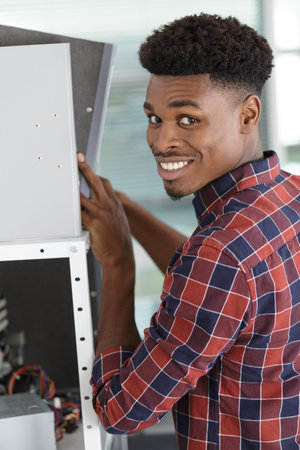 smiling casual young businessman with folder at office