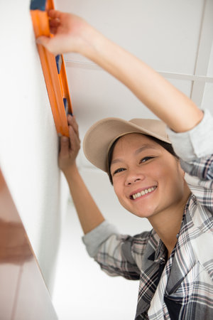closeup of a young woman using spirit levelの写真素材