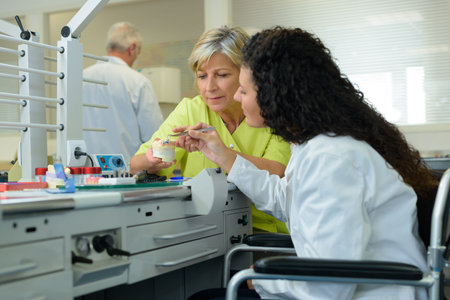 wheelchair bound female scientist working in lab