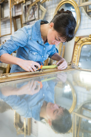 woman using measuring tape in her work in productionの写真素材