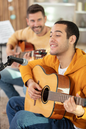 guitar teacher teaching young man
