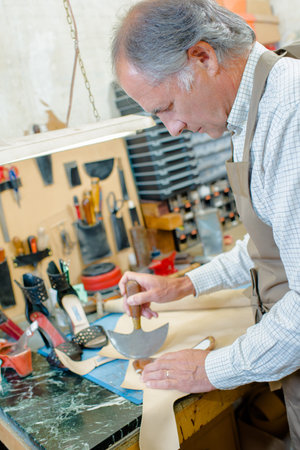 a shoe repairer creating new insoles