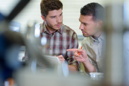 engineers at work seen through blurred foreground