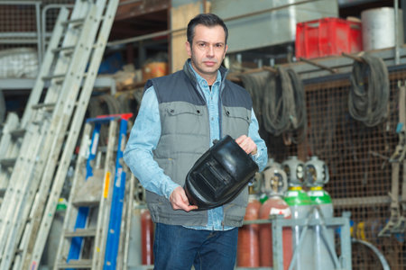 welder looking at factoryの写真素材