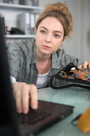 female technician repairing a landline telephoneの写真素材