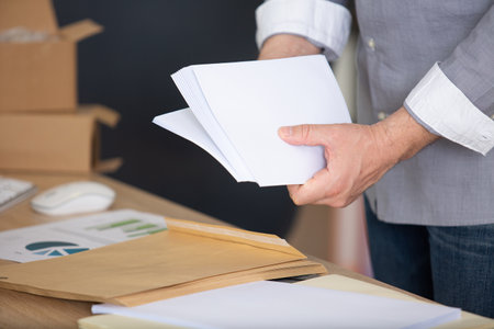 hand holding envelopes on white backgroundの写真素材