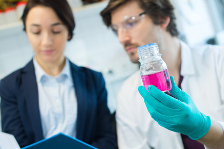male lab worker making notes
