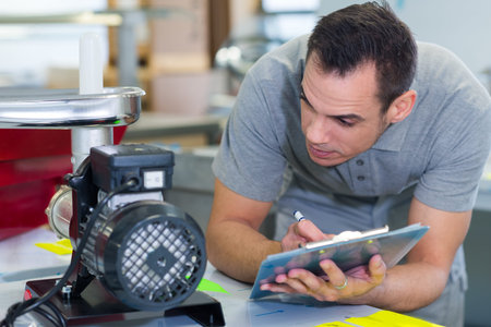 small engine technician diagnosing meat grinder